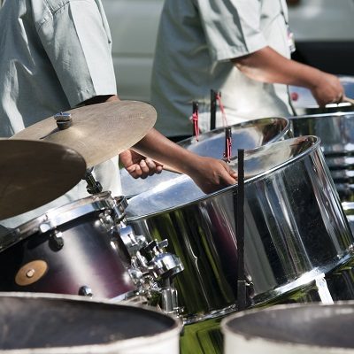 Image of some people playing the steel pans, symbolising the services for education's gala ensemble concerts.