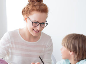 Woman teaching a little boy. Representing Phonics Screening Check – Administering the Check